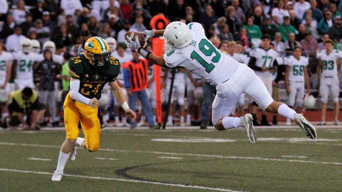 Derby junior receiver Jacob Karsak extends for a catch against Bishop Carroll in the Panthers’ 24-6 road win Friday. (Sept. 21, 2018)