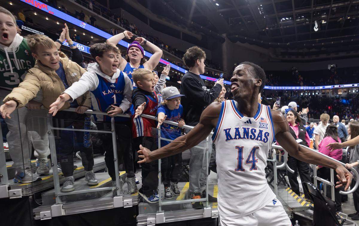 Kansas Jayhawks guard Melvin Council Jr. high-fives fans after the Jayhawks defeated rival Missouri at T-Mobile Center on Sunday, Dec. 7.