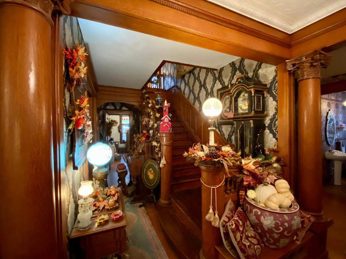 The staircase in the recently redesigned Wey Mansion is covered in the type of period wallpaper that was popular at the turn of the century.