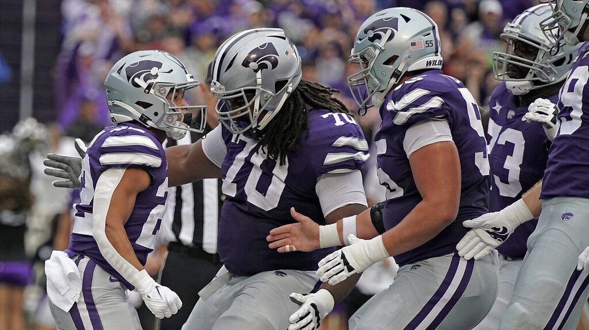 Kansas State running back Deuce Vaughn, left, celebrates with teammates after scoring a touchdown during the first half of an NCAA college football game against Missouri Saturday, Sept. 10, 2022, in Manhattan, Kan. (AP Photo/Charlie Riedel)