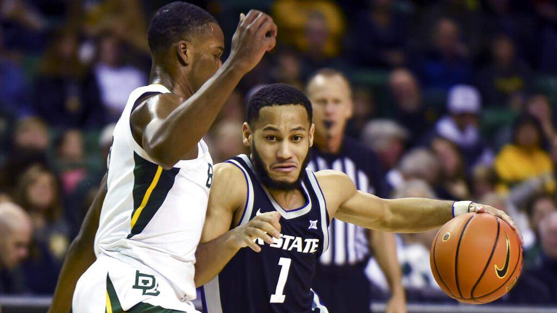 Kansas State guard Markquis Nowell (1) attempts to dribble past Baylor guard Dale Bonner (3) in the first half of an NCAA college basketball game in Waco, Texas, Tuesday, Jan. 25, 2022. (AP Photo/Emil Lippe)