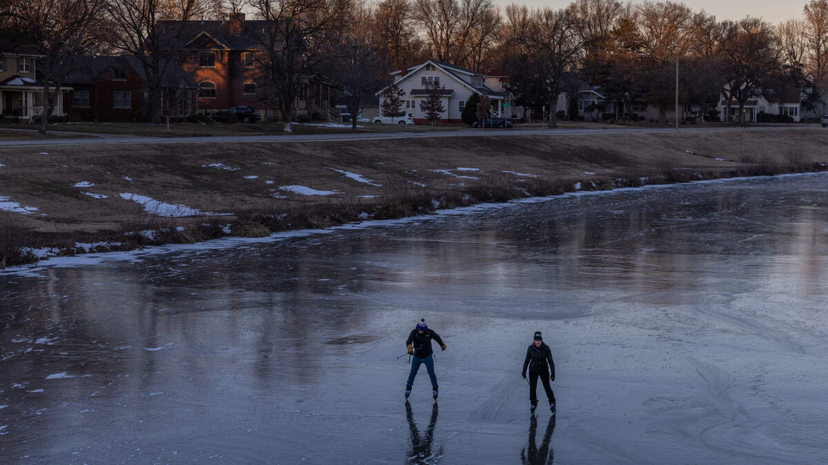 Jennifer Strong McConachie, right, and her husband Parker McConachie, ice skate on the frozen Little Arkansas River during a recent spell of sub-zero weather. Strong McConachie recently published the book “Go Multisport: Add Fun, Challenge and Exploration to your World.” 