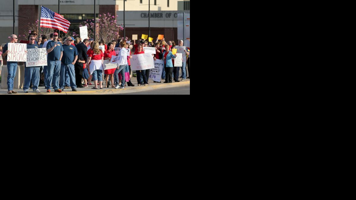 Teachers and other protesters gather in front of El Dorado Civic Center, where Gov. Sam Brownback was scheduled to appear for the Governor's One-Shot Turkey Hunt Thursday. Protesters were asking for a veto on HB 2506. (April 10, 2014)

