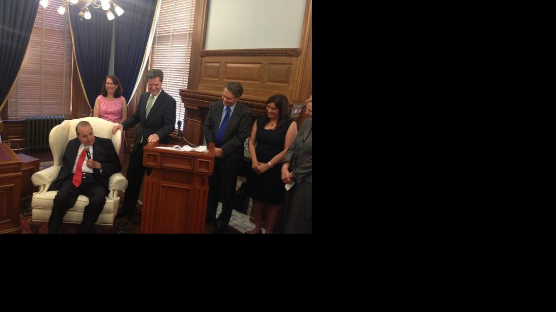 Gov. Sam Brownback smiles as former Sen. Bob Dole speaks during a ceremony in which Brownback officially filed for re-election May 15, 2014.

