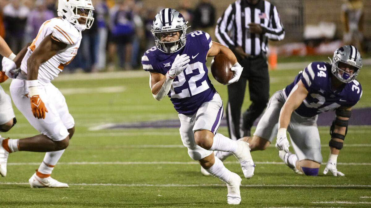 Kansas State running back Deuce Vaughn (22) carries the ball against Texas during the second half of an NCAA college football game Saturday, Nov. 5, 2022, in Manhattan, Kan. (AP Photo/Reed Hoffmann)