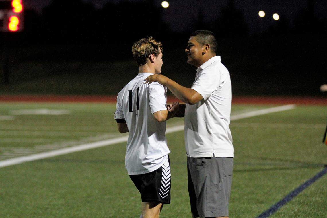 Maize South boys soccer coach Rey Ramirez thanks Maverick senior forward Bryce Bowman after a good shift in Maize South’s 5-1 win at Trinity Academy on Friday. (Aug. 24, 2018)