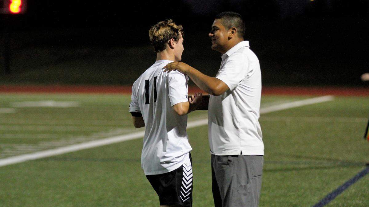Maize South boys soccer coach Rey Ramirez thanks Maverick senior forward Bryce Bowman after a good shift in Maize South’s 5-1 win at Trinity Academy on Friday. (Aug. 24, 2018)