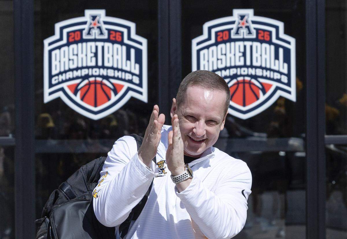 Wichita State coach Paul Mills acknowledges fans who were gathered outside of the team’s hotel as they left to play in the AAC tournament semifinal game on Saturday in Birmingham.