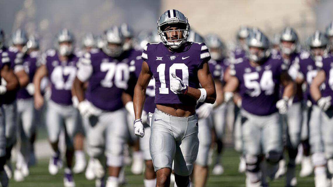 Kansas State players run onto the field before an NCAA college football game against TCU, Saturday, Oct. 30, 2021, in Manhattan, Kan. (AP Photo/Charlie Riedel)