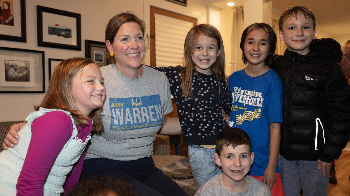 Amy Warren takes a picture with young supporters during an election night party at her home. Warren appeared to have won the election for Wichita school board District 6, defeating incumbent Hazel Stabler. 