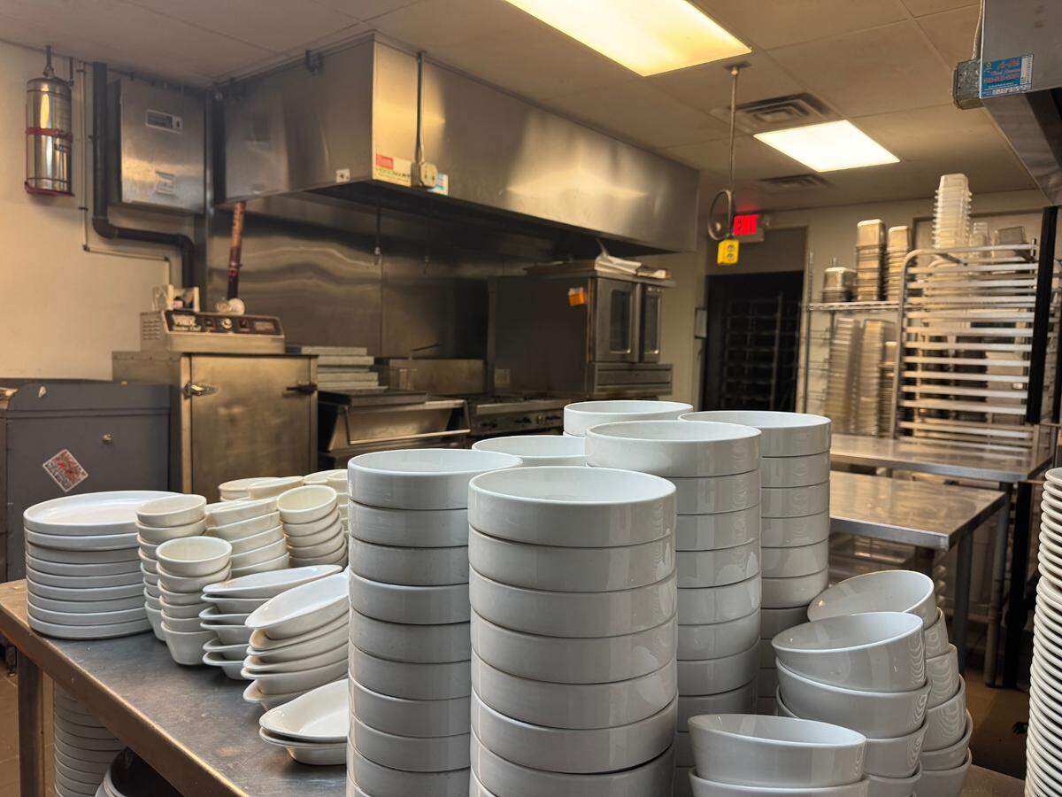 Dishes were stacked in the kitchen behind the old Anchor Meat Market during an opening house at the property on Thursday.