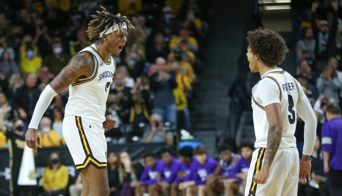 Wichita State’s Monzy Jackson celebrates a big play with teammate Craig Porter Jr. on Tuesday at Koch Arena.