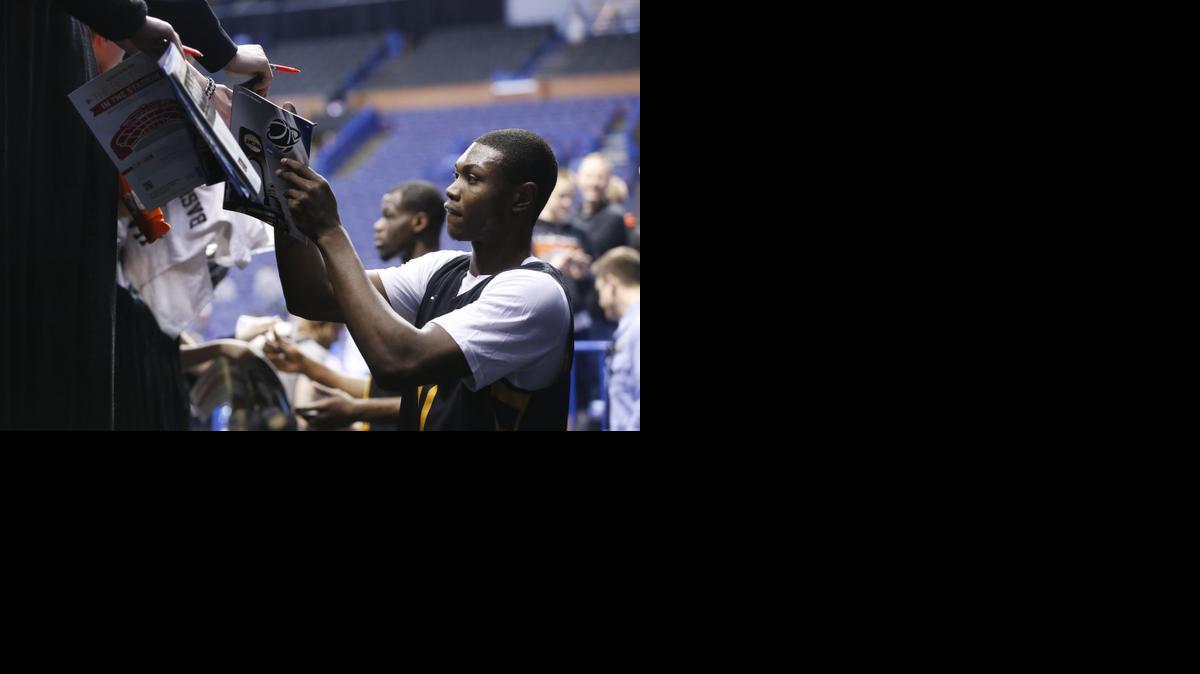 Wichita State's Cleanthony Early signs autographs after a practice at Scottrade Center. WSU will face Cal Poly in the second round of the NCAA tournament. 


