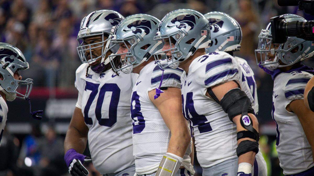 Kansas State Wildcats offensive lineman KT Leveston (70) and tight end Ben Sinnott (34) and quarterback Will Howard (18) celebrates a touchdown against the TCU Horned Frogs at AT&T Stadium.