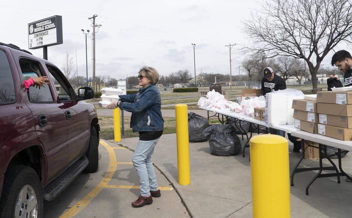 Karen Padzensky delivers food to people at Truesdale Middle School. (March 23, 2020)