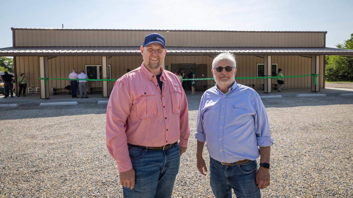 Farha Construction CEO Ted Farha, right, and vice president Todd Hinshaw stand outside the new activity center they built in Clearwater for the Girl Scouts of Kansas Heartland. Farha has expanded his company’s business to include construction of steel buildings for various uses.