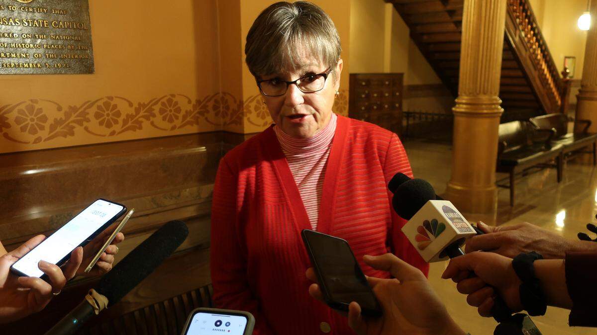 In this photo from Thursday, June 10, 2021, Kansas Gov. Laura Kelly answers questions from reporters at the Statehouse in Topeka. Kelly on Tuesday issued a new executive order that expands paid parental leave for state workers. (AP Photo/John Hanna)