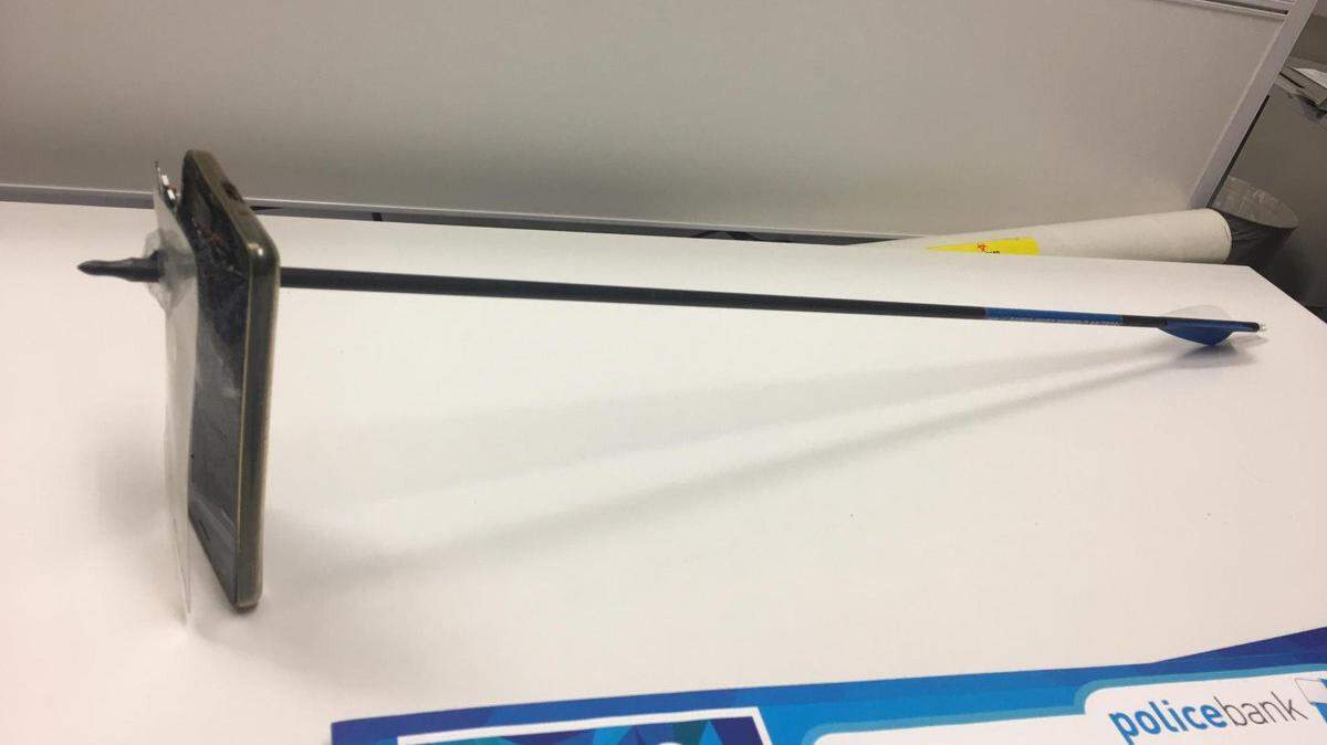 A smart phone stopped an arrow from striking a man who was taking a photo, Australian police said.