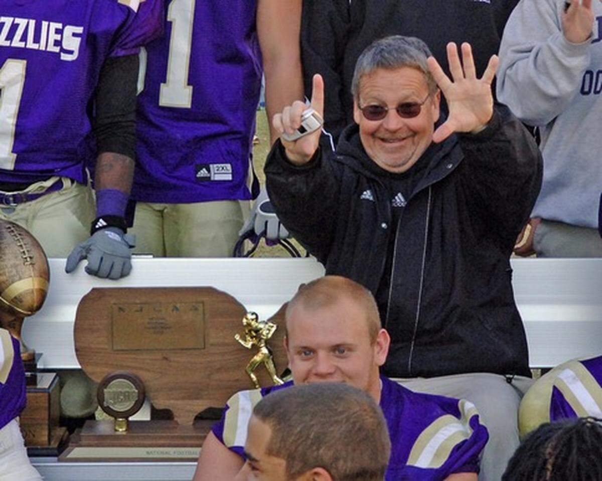 Former Butler football coach Steve Braet celebrates after winning his sixth national championship with the Grizzlies.