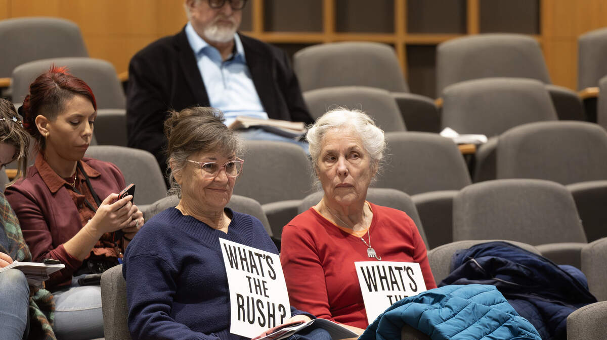 Signs in the audience at a recent Wichita City Council meeting express disapproval about a possible new sales tax. The council voted to place the proposal on a March 3 special election ballot.