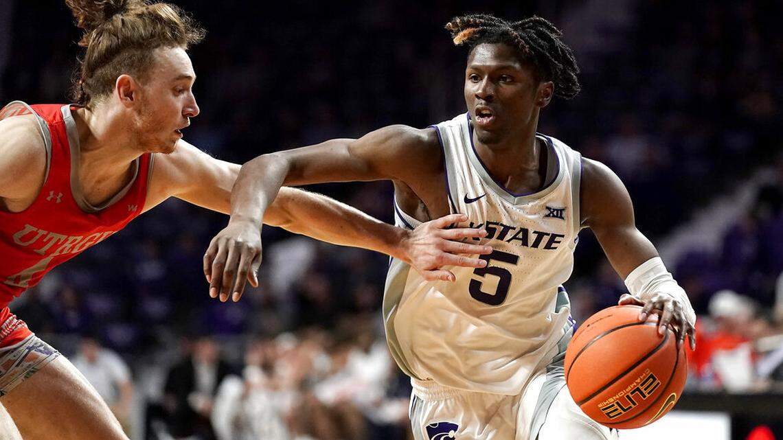 Kansas State guard Cam Carter (5) drives under pressure from Texas-Rio Grande Valley guard Will Johnston (4) during the second half of an NCAA college basketball game Monday, Nov. 7, 2022, in Manhattan, Kan. (AP Photo/Charlie Riedel)