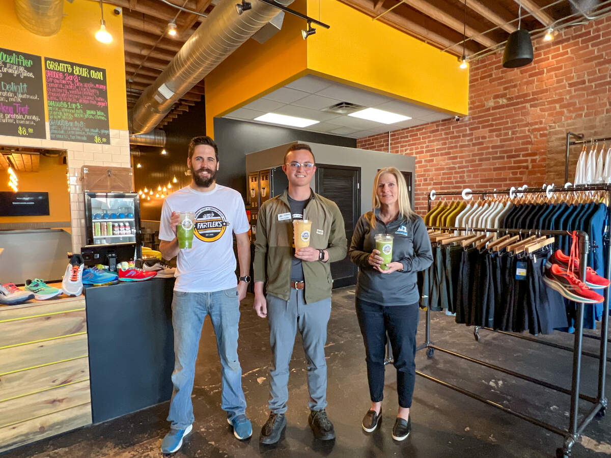 Andrew Schinstock, left, has opened Fartleks Running Shop Smoothie Stop in Delano. Nick Flores of Occidental Management, center, handled the deal for the space. Commerce Construction Services remodeled the space. Also pictured is Commerce’s Susan Lentz.
