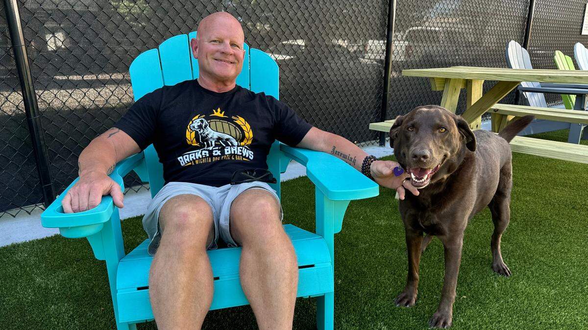 Kris Withrow, pictured here with his chocolate lab, Harley, is the owner of the new Barks & Brews ICT dog park and bar, which opens on Friday.