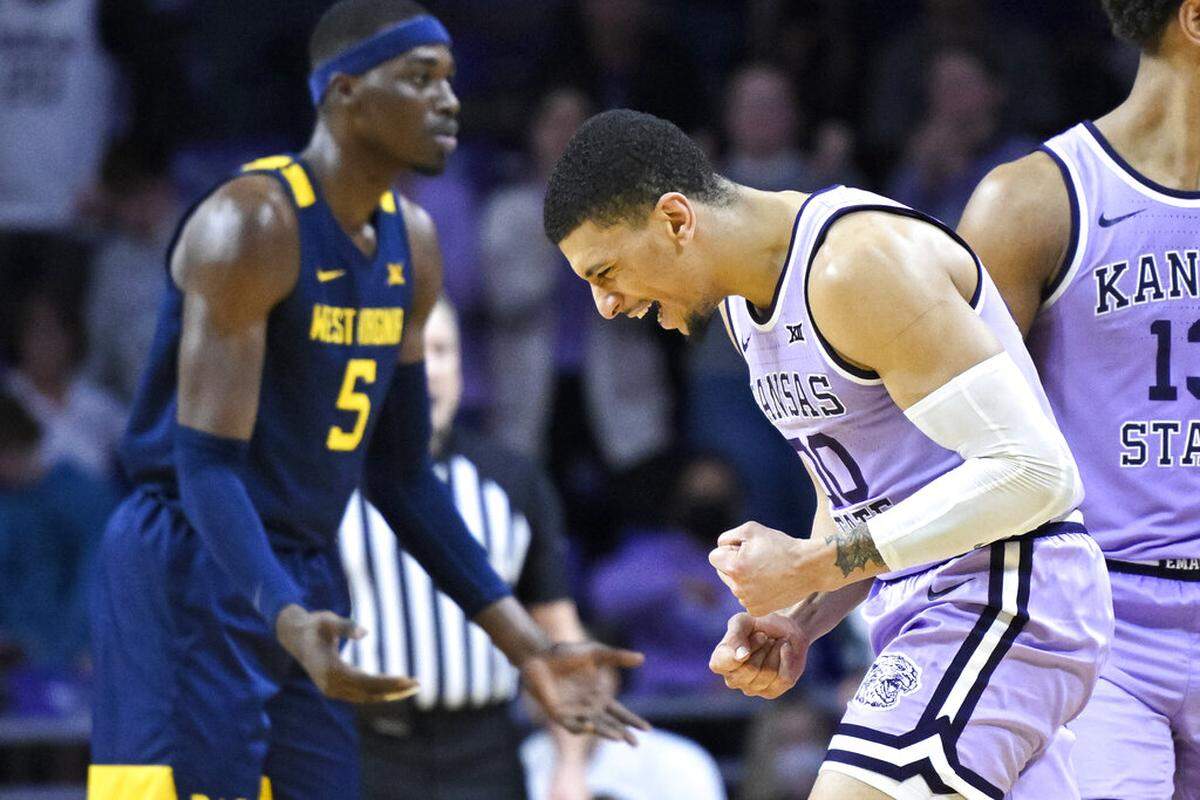 Kansas State guard Mike McGuirl, right, celebrates as time runs out in the team’s recent win against West Virginia.