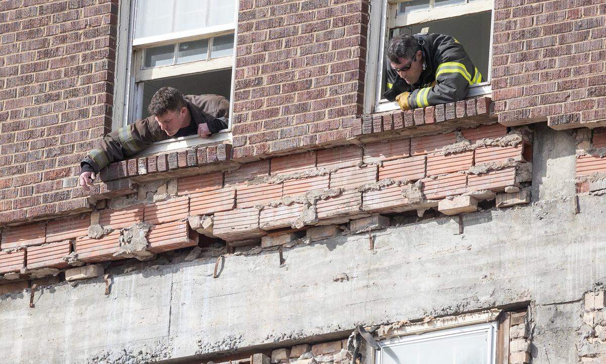 Firefighters examines a section of the Commodore building on north Broadway after a large section of bricks collapsed off of the building’s south side. No one below was injured.
