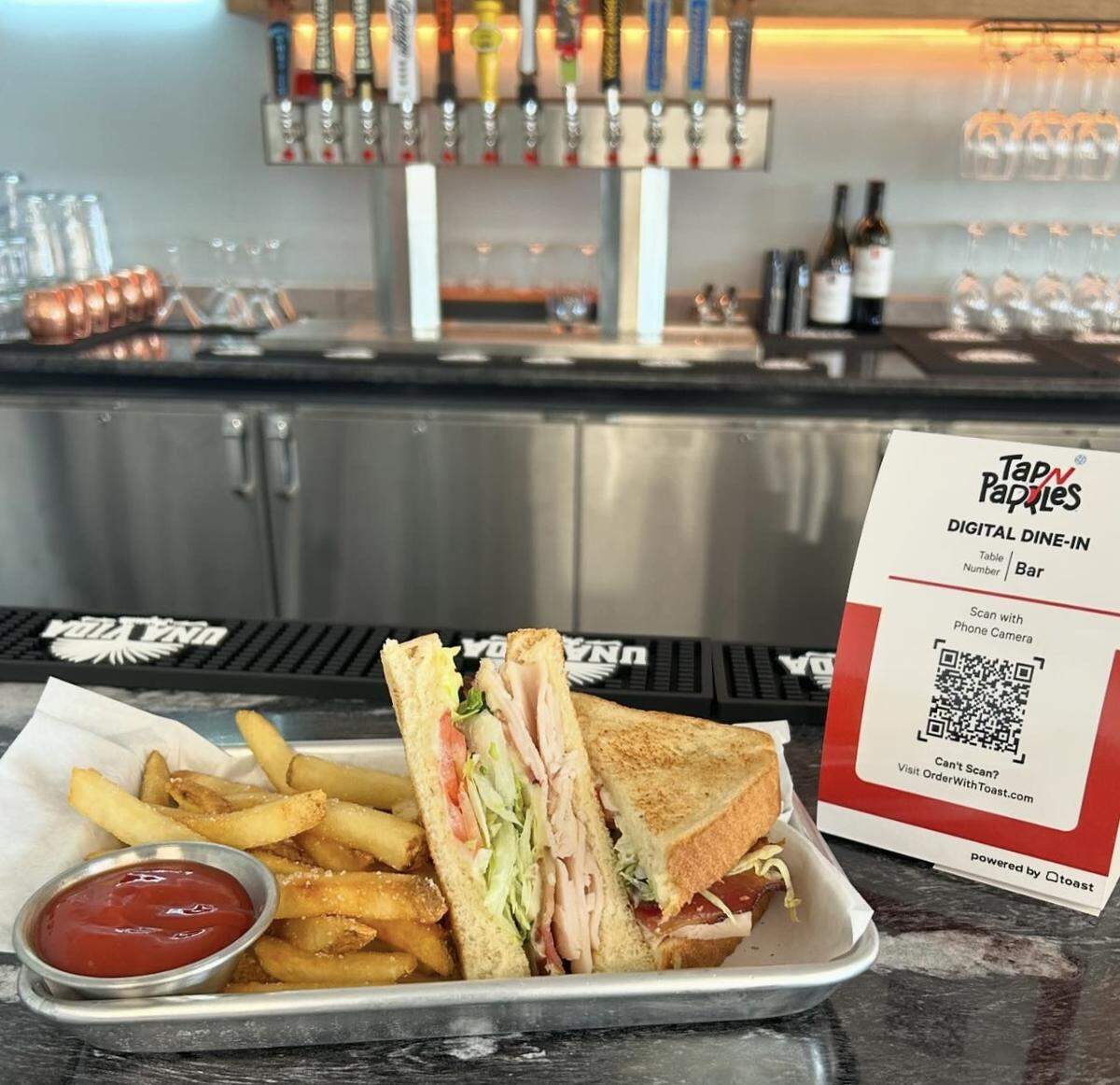 The restaurant at Tap N Paddles also features a bar with cocktails, wine, and beer on tap.