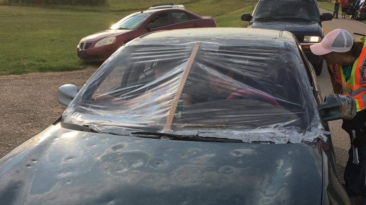 The broken windshield on this car was “fixed” with plastic, wood, duct tape and a can of carrots, photos show. Nebraska state troopers did not allow the car to continue driving on the road.