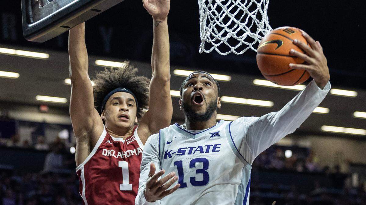 Kansas State’s Desi Sills makes a reverse lay-up against Oklahoma’s Jalen Hill during the second half on Wednesday night in Manhattan.