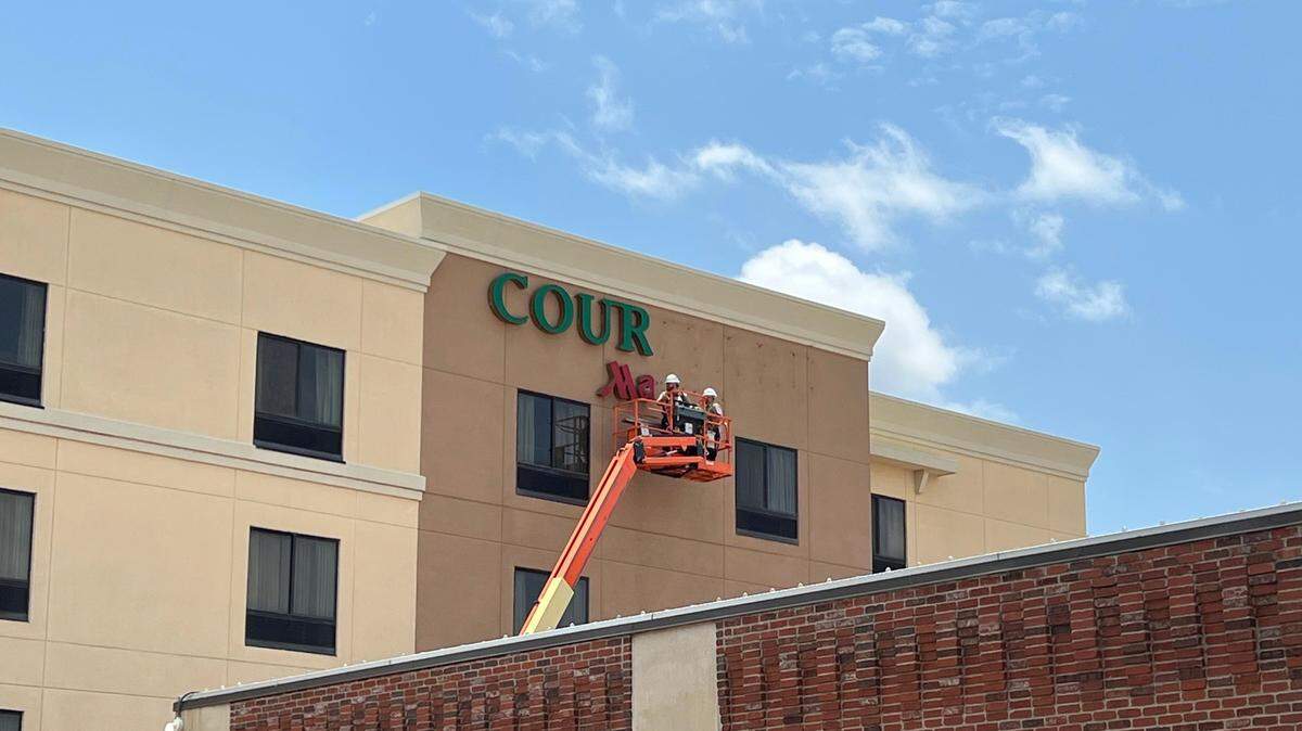 The signs at the Courtyard by Marriott at Old Town were being dismantled on Wednesday in preparations for new ones. More remodeling will happen later this year.