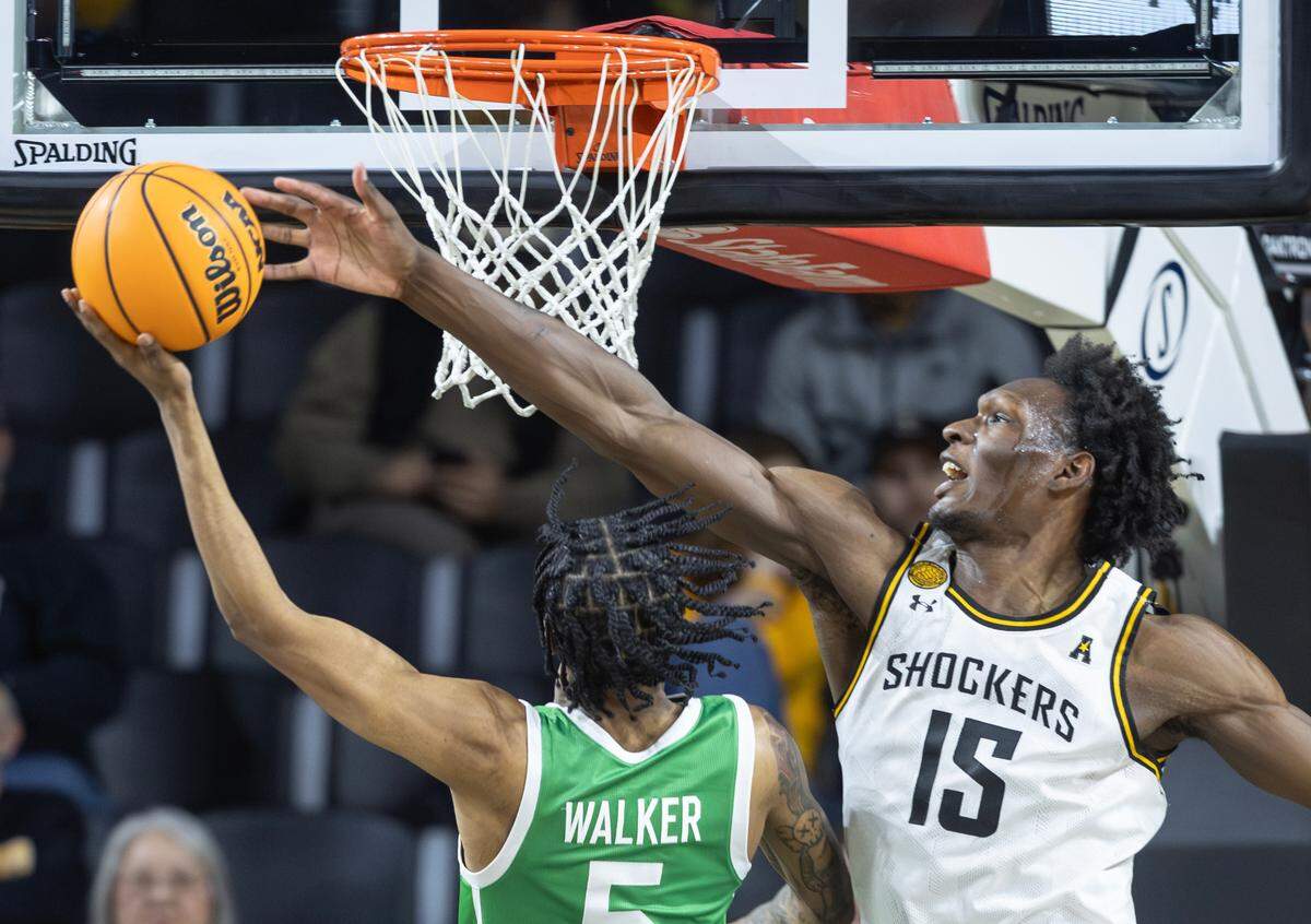 Wichita State’s Quincy Ballard blocks the shot of North Texas’ Rondel Walker during a game this past season.