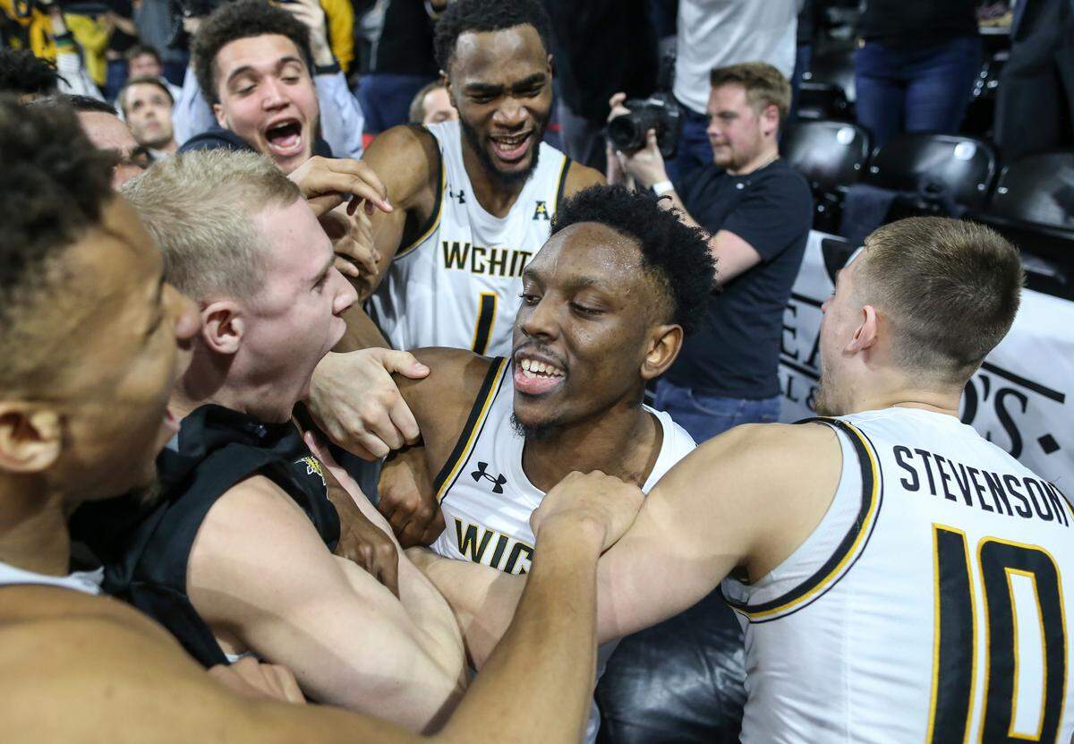 Wichita State guard Samajae Haynes-Jones is mobbed by teammates after hitting the game winning shot against Connecticut on Thursday night.
