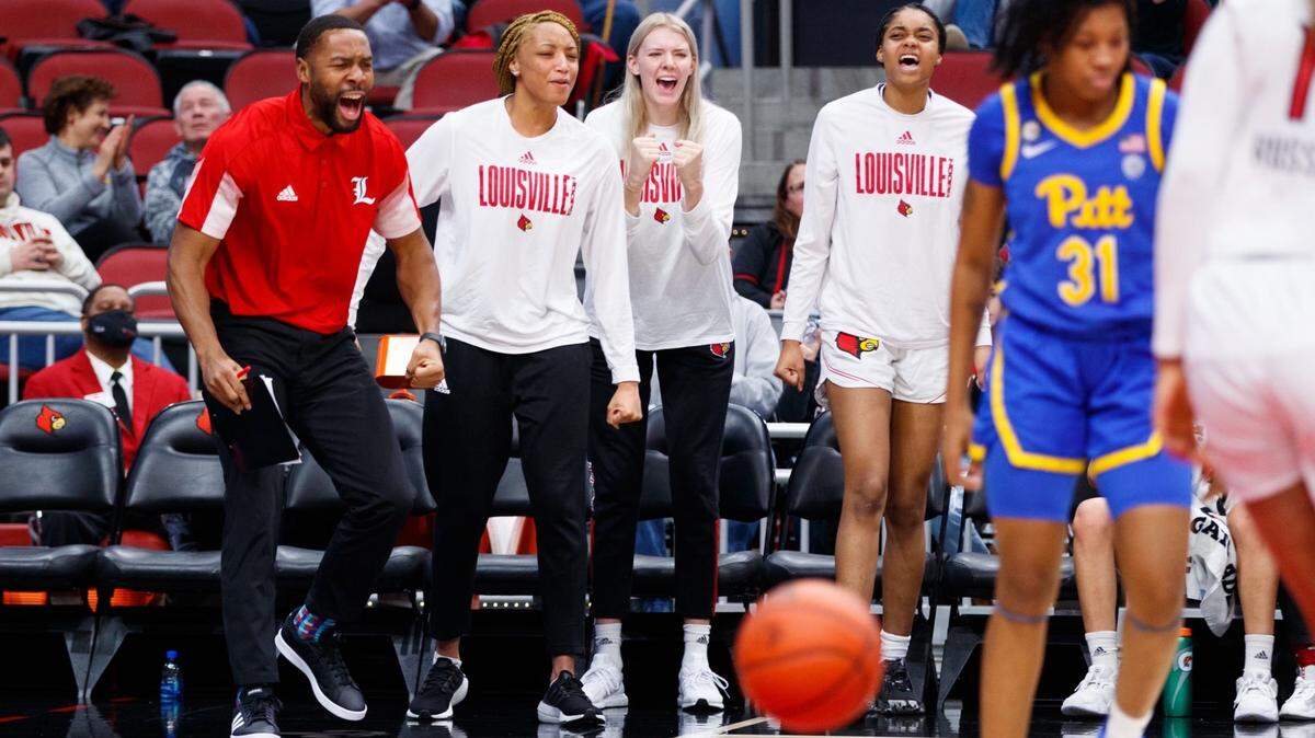 Wichita native LaMont Russell (far left) has enjoyed his stint with the Louisville women’s basketball team, one of the premier programs in the country.
