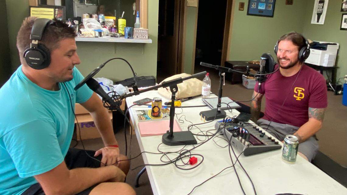 Wichita Brewing Company’s head brewer Cody Sherwood, left, and co-owner Jeremy Horn, right, record an episode of their new podcast “Under the Lid” inside their business office in their production facility in south Wichita.