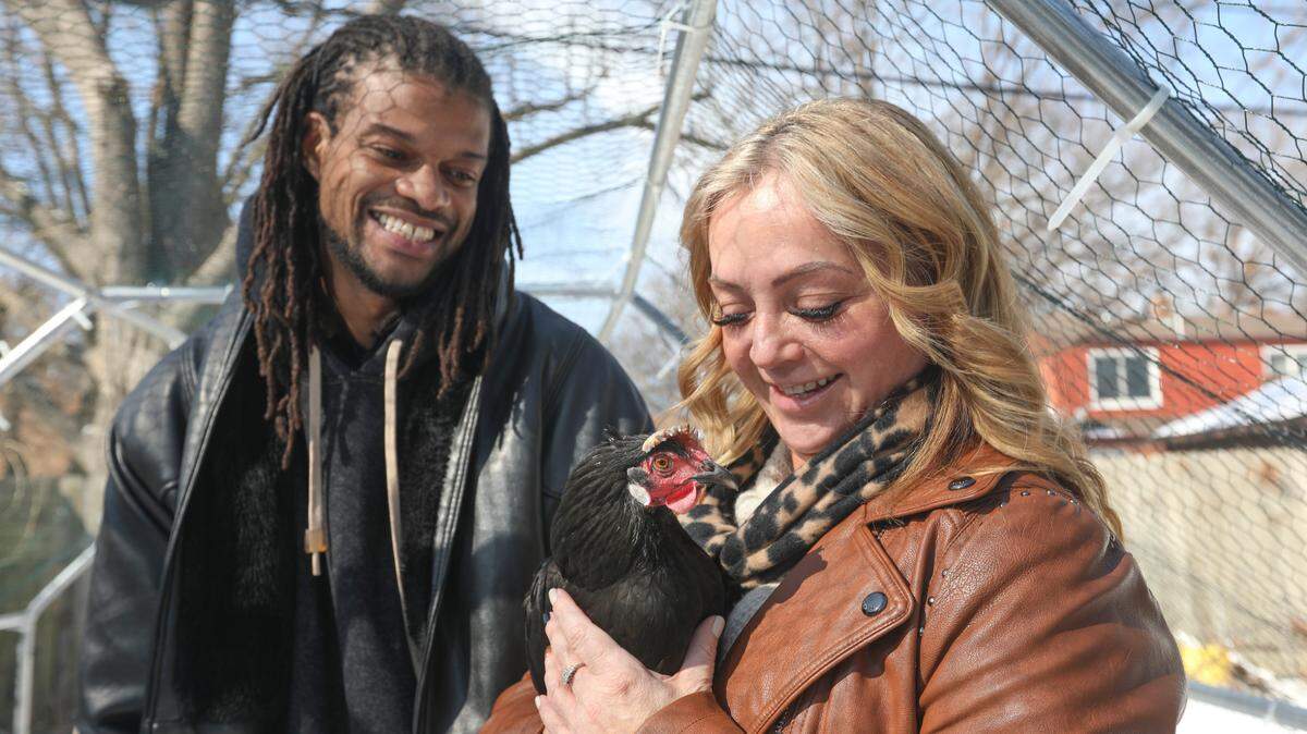 Kareem Collins and Lisa Aguilera with Betty, a chicken they helped rescue after she’d been running loose on Belmont as temperatures fell dangerously.