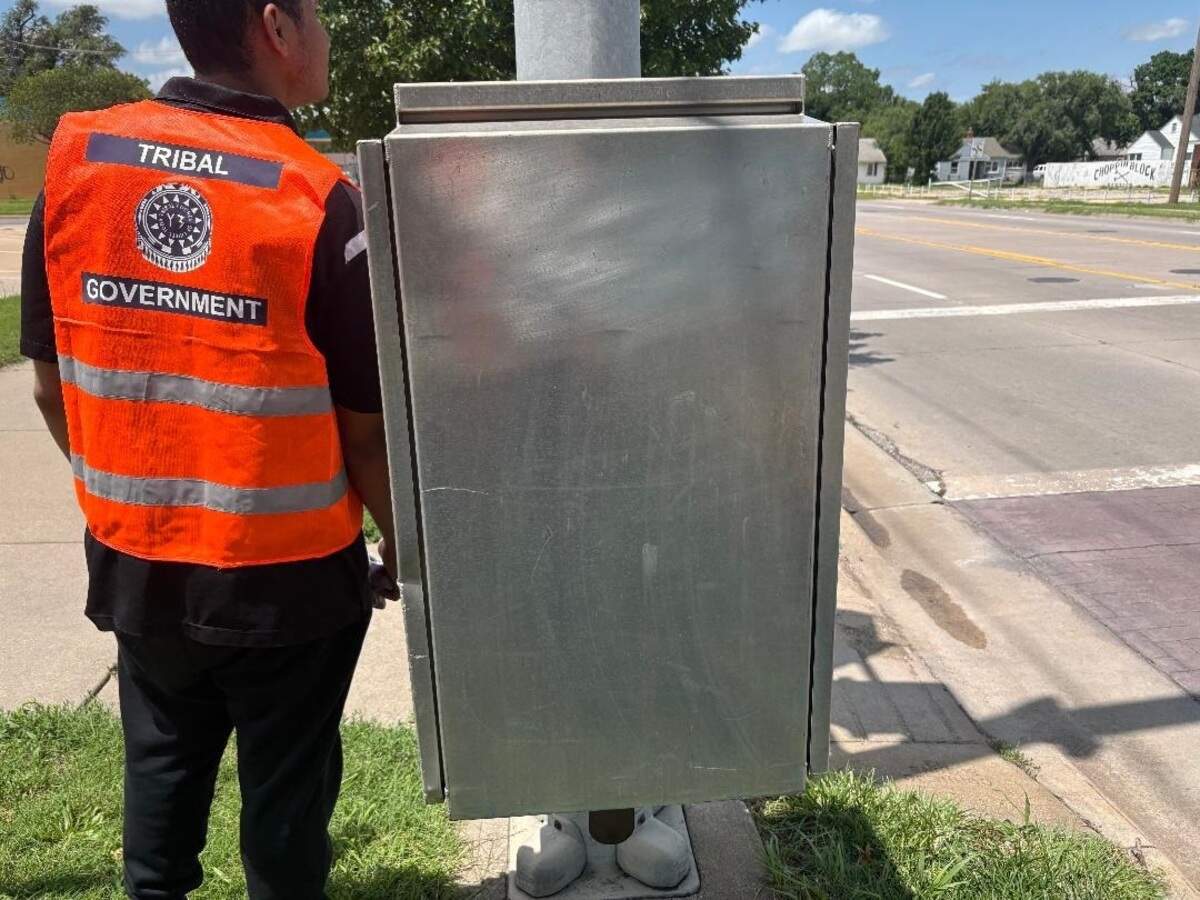 A volunteer with the Juda Graffiti Removal and Deterrence Task Force stands next to a recently repainted electrical box on 21st after the piece of city property had been tagged by graffiti.