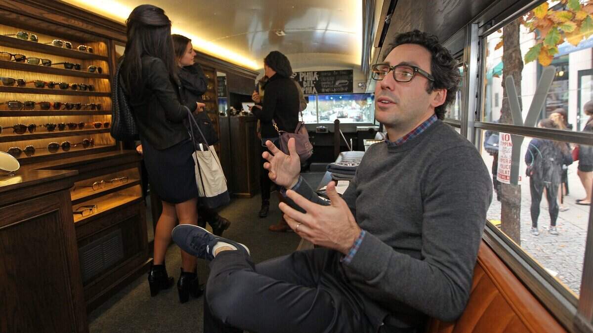 Neil Blumenthal, one of the founders of Warby Parker, talks about his business vision aboard a tour bus in this file photo. The eyewear chain is coming to Bradley Fair in Wichita.