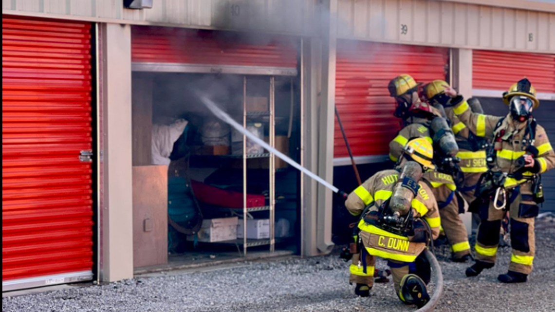 Firefighters worked Tuesday morning to put out a fire at a Hutchinson storage unit facility. One person who appeared to be living inside a unit died.