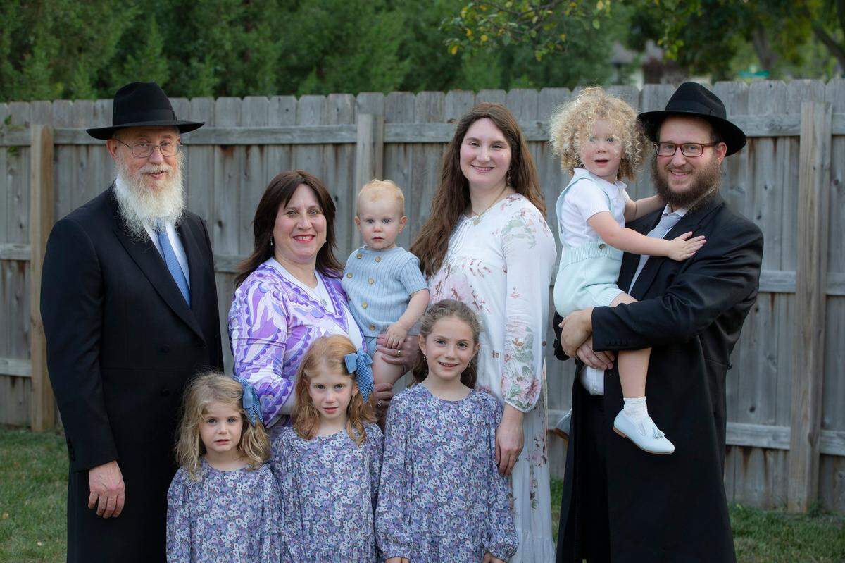 Rabbi Shmulik Greenberg, right, and his wife, Rebbetzin Chaya Greenberg, third from right, have found new space for their Chabad of Wichita and Rural Kansas at the Shops at Tallgrass. Pictured with them are their children, Menachem, in his father’s arms; Moshe, in the arms of Rabbi Greenberg’s mother, Rebbetzin Chana Greenberg of El Paso; and daughters Zelda, Shaina, Shterna, from right to left. Also pictured is Rabbi Greenberg’s father, Rabbi Yisroel Greenberg El Paso.
