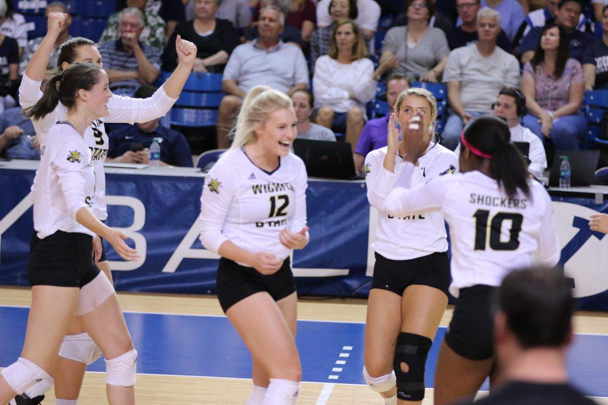 Regan Stiawalt (center) celebrates with her Wichita State teammates after a point.