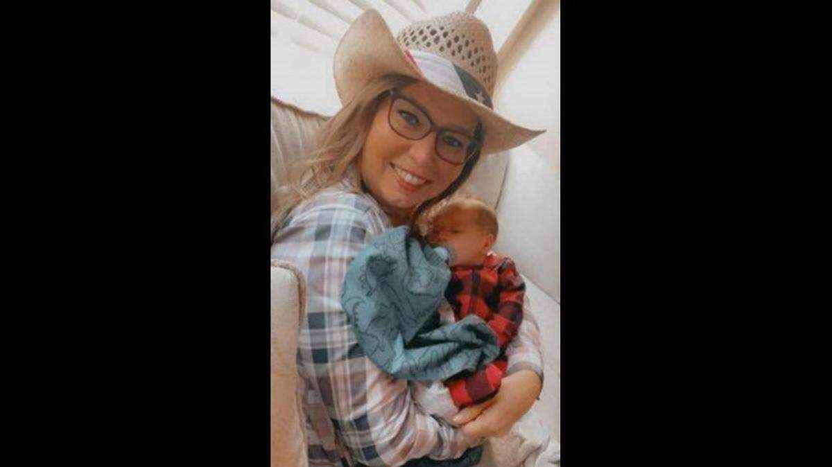 Kacy Joel poses for a photo with her newborn grandson, Grayson Fults. The 46-year-old was killed Tuesday in Wichita.