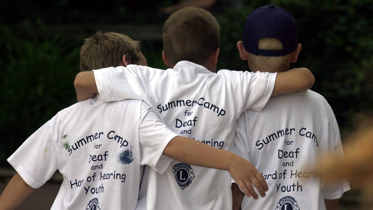 Three campers at a day camp at Eberly Farm walk with their arms around each other to an activity in this file photo. St. John Paul II Independent Catholic School has now purchased Eberly Farm.