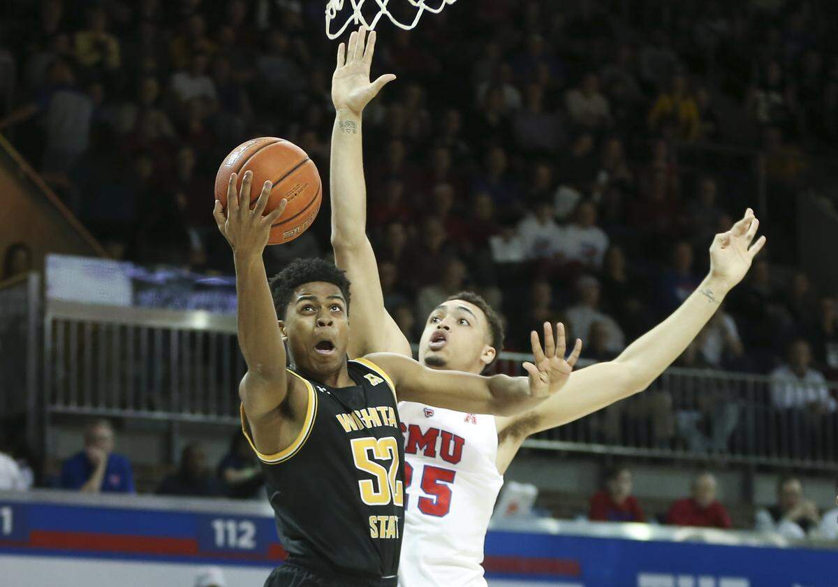 Wichita State’s Grant Sherfield takes a shot agains SMU’s Ethan Chargois during the first half on Sunday in Dallas.