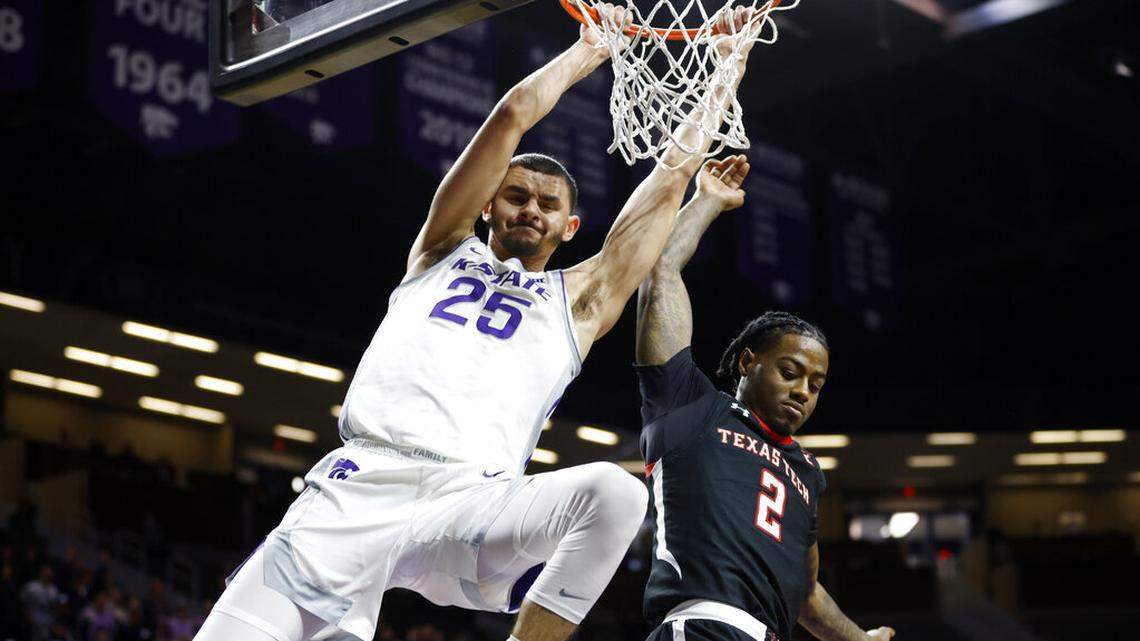 Kansas State forward Ismael Massoud (25) scores against Texas Tech guard Davion Warren (2) during the second half of an NCAA college basketball game on Saturday, Jan. 15, 2022 in Manhattan, Kan. (AP Photo/Colin E. Braley)