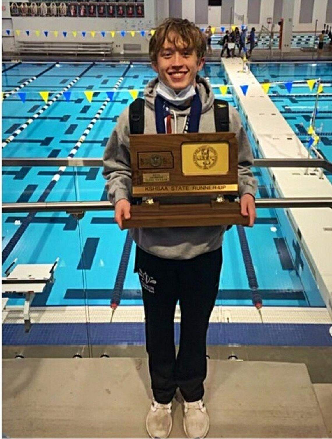 Kapaun Mt. Carmel freshman Frank Alberti poses with the Crusaders’ second-place team trophy at state swimming. Alberti won the Class 5-1A title in the 100-yard backstroke.