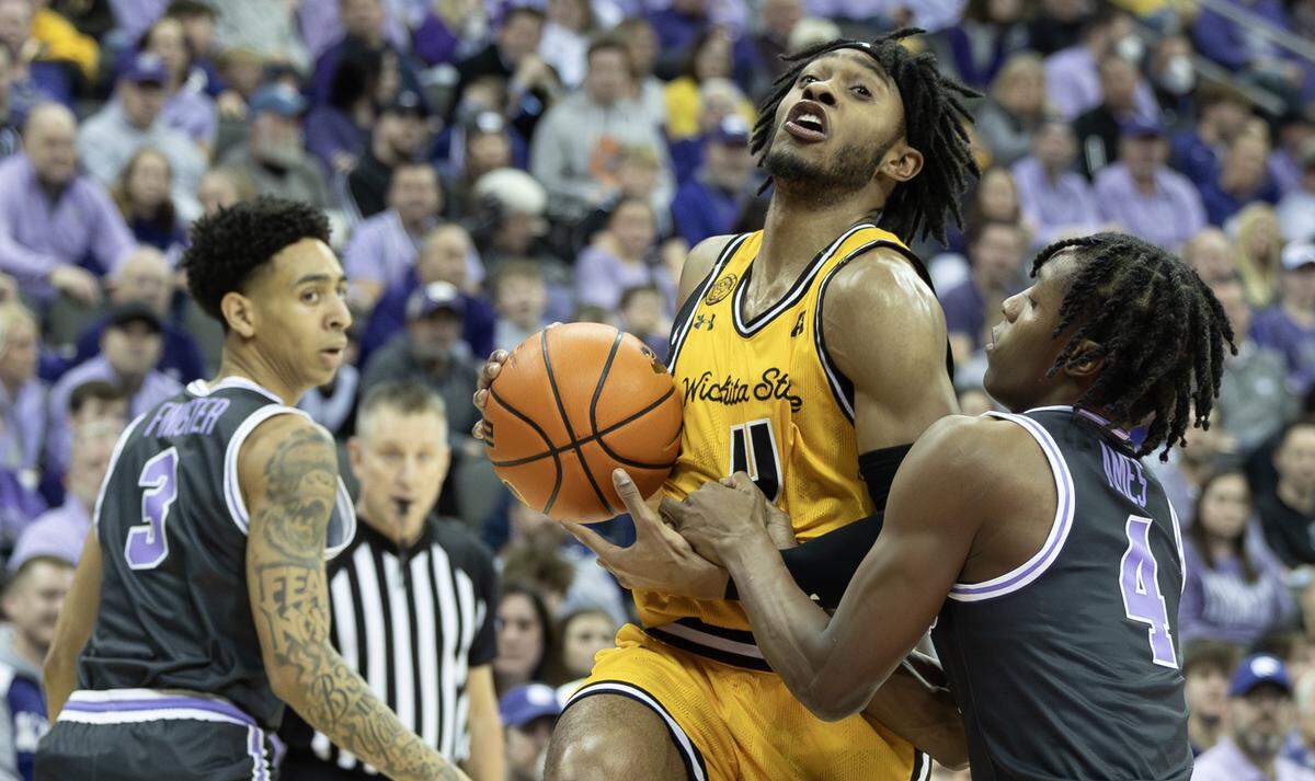 Wichita State’s Colby Rogers is fouled by Kansas State’s Dai Dai Ames during the second half of Kansas State’s 69-60 win over the Shockers on Thursday night at the T-Mobile Center in Kansas City. 