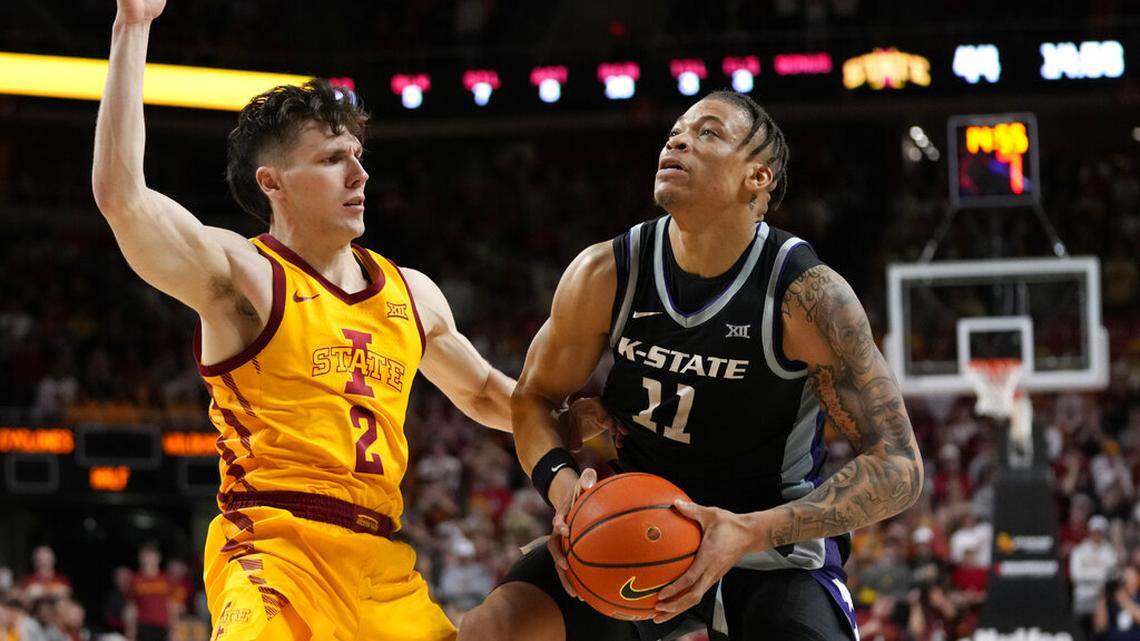 Kansas State forward Keyontae Johnson (11) drives past Iowa State guard Caleb Grill (2) during the second half of an NCAA college basketball game, Tuesday, Jan. 24, 2023, in Ames, Iowa. (AP Photo/Charlie Neibergall)